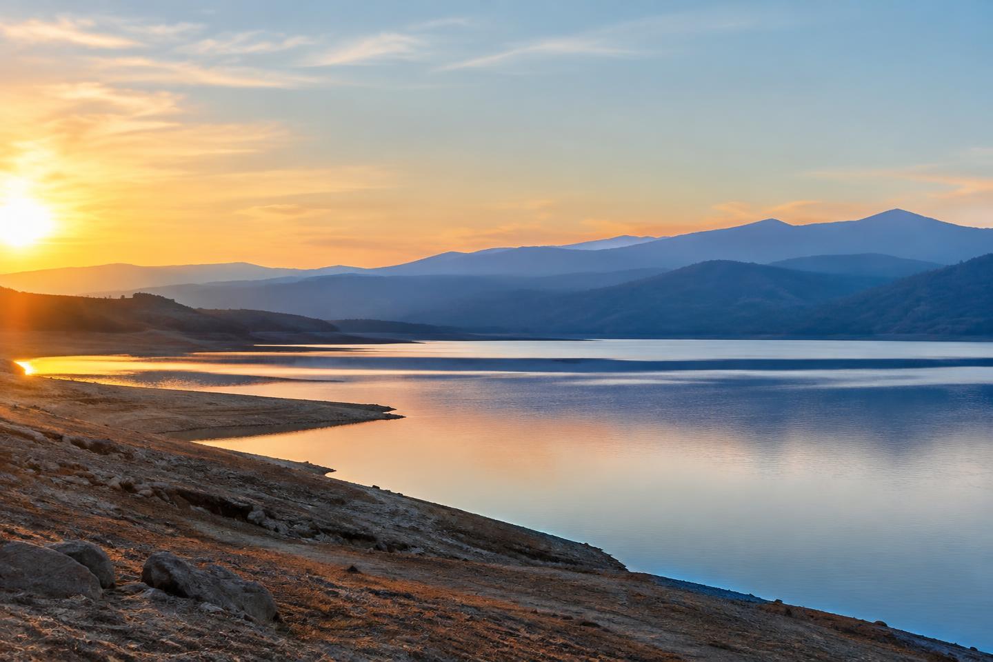 Folsom Lake and layered Sierra foothills at dawn.